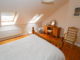 A bedroom with a bed and desk with a mirror at Aisling in Foxford near Ballina, County Mayo