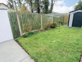 A garden featuring a fence, grass, a shed, and a clothesline at Aisling in Foxford near Ballina, County Mayo