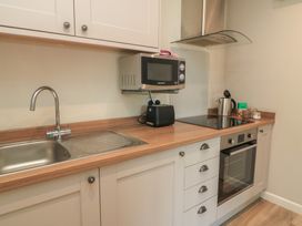 A kitchen with a sink and various appliances at The Cider Press, Motcombe