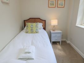 A bedroom with a single bed and a nightstand at The Cider Press, Motcombe