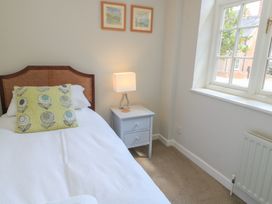 A bedroom with a bed and nightstand at The Cider Press, Motcombe