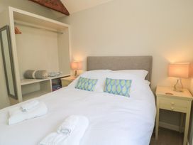 A bedroom with a double bed and bedside table at The Cider Press, Motcombe