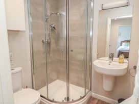 A bathroom with a shower, toilet and sink at The Cider Press, Motcombe