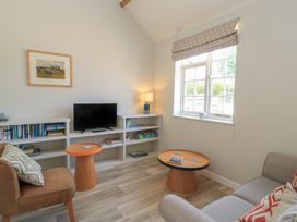 A living room with a sofa and television at The Apple Shed, Motcombe