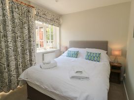 A bedroom with a bed and window at The Apple Shed, Motcombe