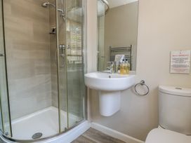 A bathroom with a shower, sink and toilet at The Apple Shed, Motcombe