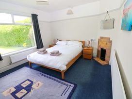 A bedroom with a double bed and window at White Thorns in Haverfordwest