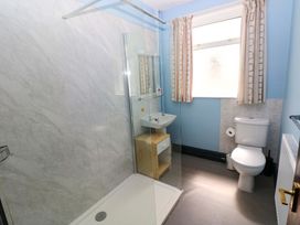 A bathroom with a shower, sink, and toilet at White Thorns in Haverfordwest