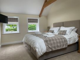 A bedroom with a double bed and folded towels on it at The Groom's Cottage in Goodmanham Wold near Market Weighton
