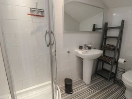 A bathroom with a shower, sink and toilet at Little Orme View in Llandudno