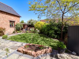 A garden with a stone path and plants at The Linhay Washford near Watchet