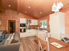 A kitchen with dining area and sofa at Elm Lodge in Ulverston