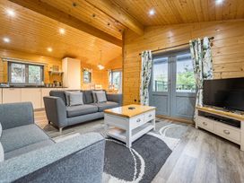 A living room with a sofa and coffee table at Elm Lodge in Ulverston