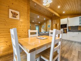 A dining area with a table and chairs at Elm Lodge in Ulverston