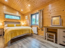 A bedroom with a bed and dressing table at Elm Lodge in Ulverston