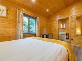 A bedroom with a bed and vanity at Elm Lodge in Ulverston
