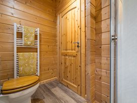A bathroom with a toilet and towel rack at Elm Lodge in Ulverston