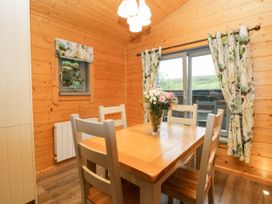A dining room with a table and chairs at Elm Lodge in Ulverston