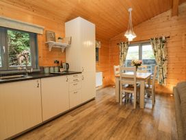 A kitchen with a dining table and chairs at Elm Lodge in Ulverston