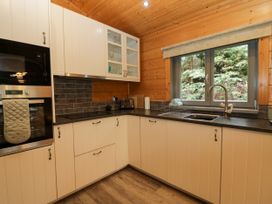 A kitchen with a sink and oven at Elm Lodge in Ulverston