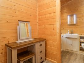 A bathroom with a mirror and sink at Elm Lodge in Ulverston