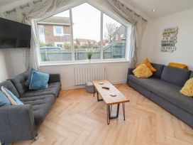 A living room with a sofa and coffee table at Sunrise Cottage in Beadnell