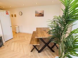 A dining room with a table and chairs at Sunrise Cottage in Beadnell