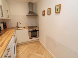 A kitchen with a sink and stove at Sunrise Cottage in Beadnell