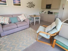 A living room with a sofa and table at Bre An Mor in Praa Sands
