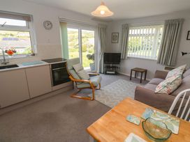 A living room with a kitchen and seating area at Bre An Mor in Praa Sands