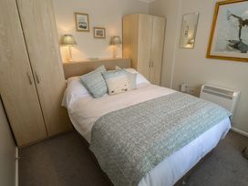A bedroom with a bed and wardrobe at Bre An Mor in Praa Sands