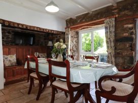 A dining room with a table and chairs at Penrose Farm Cottage St Keverne
