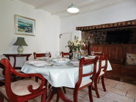 A dining room with a table set for six at Penrose Farm Cottage St Keverne