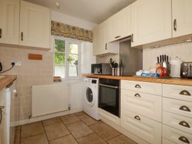 A kitchen with appliances and storage at Penrose Farm Cottage St Keverne