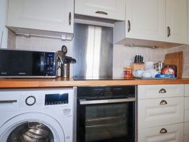 A kitchen with appliances and utensils at Penrose Farm Cottage St Keverne