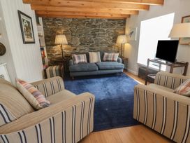 A living room with a sofa and armchairs at Pegs in Porthleven
