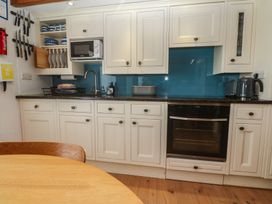 A kitchen with cabinets and appliances at Pegs in Porthleven