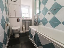 A bathroom with a toilet, sink, and bathtub at Pegs in Porthleven