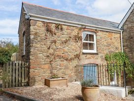 A stone exterior with a window and gate at Mithian Cottage St Agnes