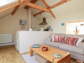 A living room with a sofa and coffee table at Mithian Cottage in St Agnes