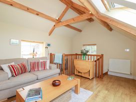 A living room with a sofa and coffee table at Mithian Cottage in St Agnes