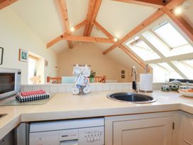 A kitchen with a sink and microwave at Mithian Cottage in St Agnes