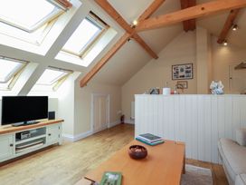 A living room with a television and skylights at Mithian Cottage in St Agnes