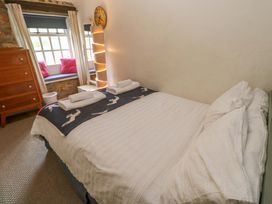 A bedroom with a bed and a chest of drawers at May Cottage Pentewan