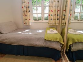 A bedroom with a bed and towels on it at May Cottage in Pentewan