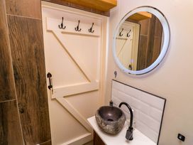 A bathroom with a sink and mirror at May Cottage Pentewan