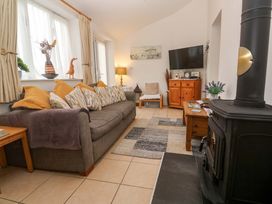 A living room with a sofa and television at Godrevy Cottage in Hayle