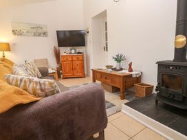 A living room with a sofa and television at Godrevy Cottage Hayle