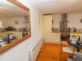 A kitchen with a table and chairs at Godrevy Barn in Hayle