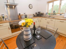 A kitchen with a table set for two at Godrevy Barn Hayle